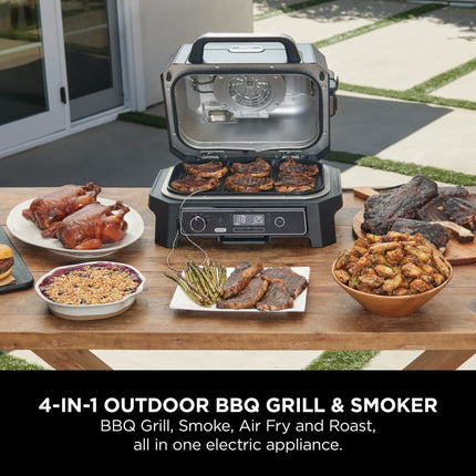 4-in-1 outdoor BBQ grill and smoker with food on a wooden table
